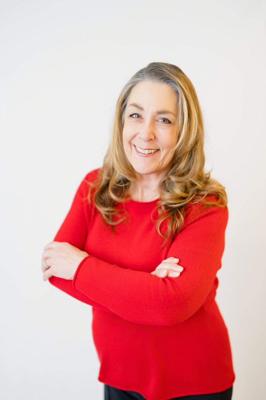 Tracy Goodwin, arms crossed, smiling